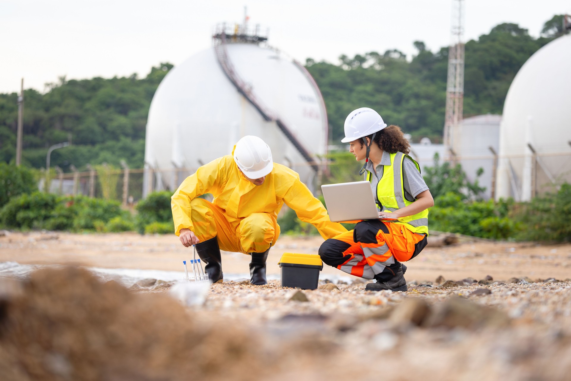 Environmental Scientists Testing Polluted Water Near Industrial Drain, Workers Collecting Water Samples for Environmental Research, Engineers Analyzing Environmental Data on a Beach Cleanup Project